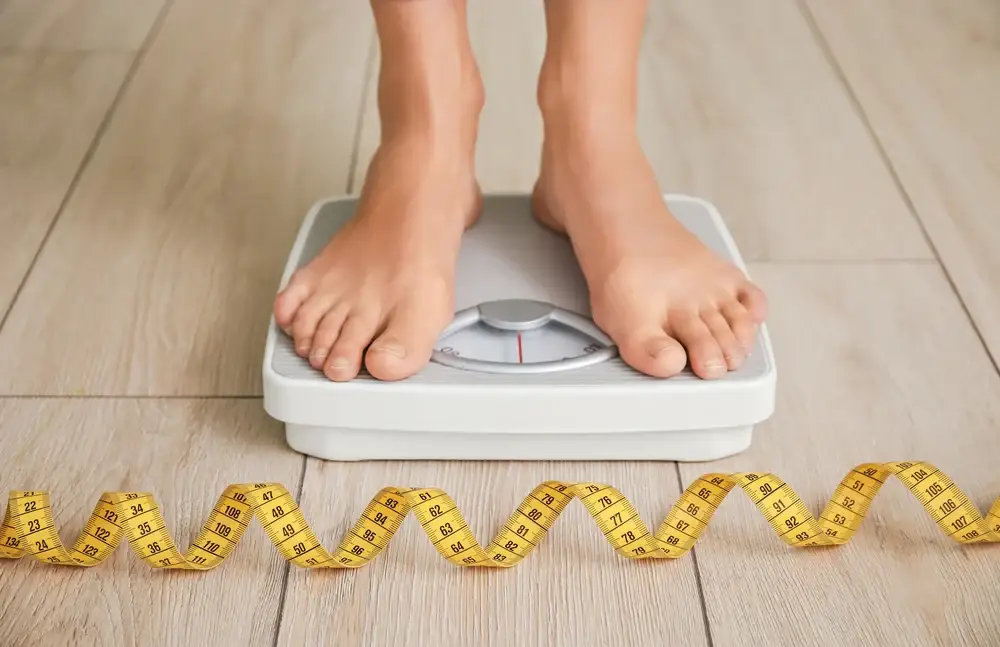 Foot on machine to check weight